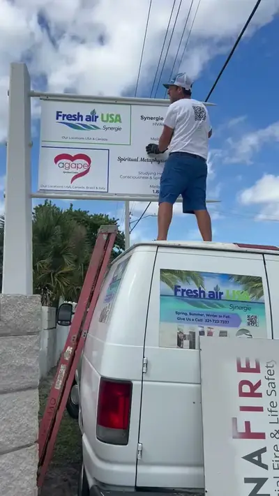 Crew mounting signage above the Synergie premises