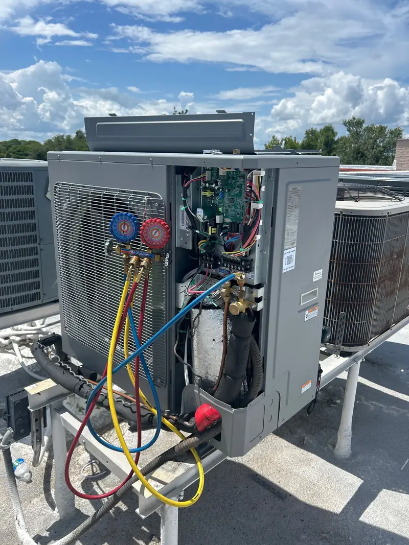 Refrigerant gauges connected to a rooftop unit