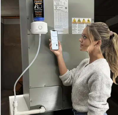 Homeowner checking an indoor air quality monitor