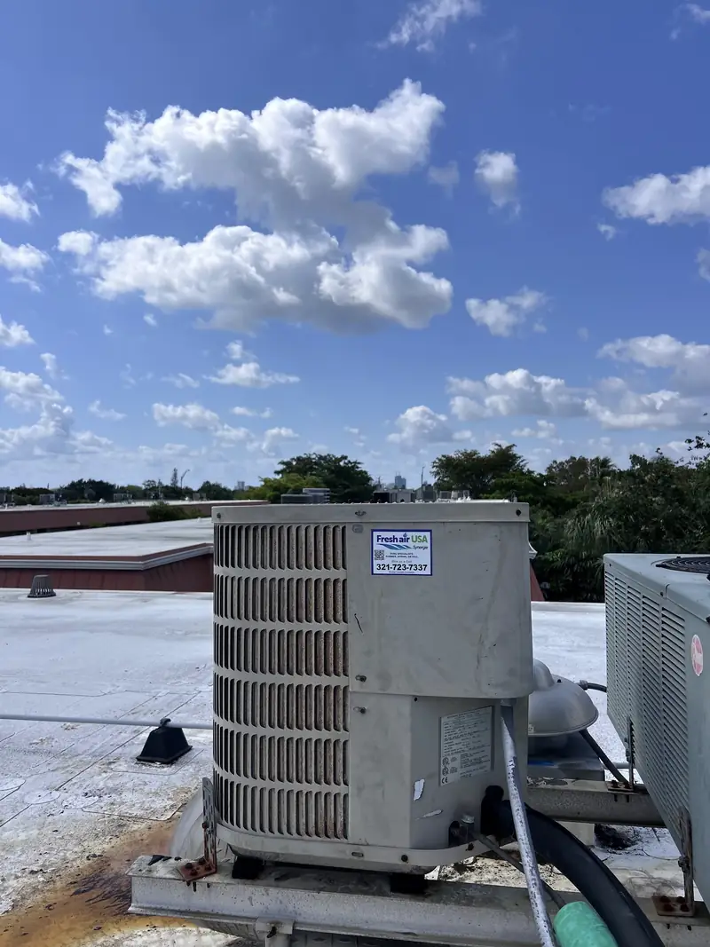 Rooftop commercial condensing units under a Florida sky