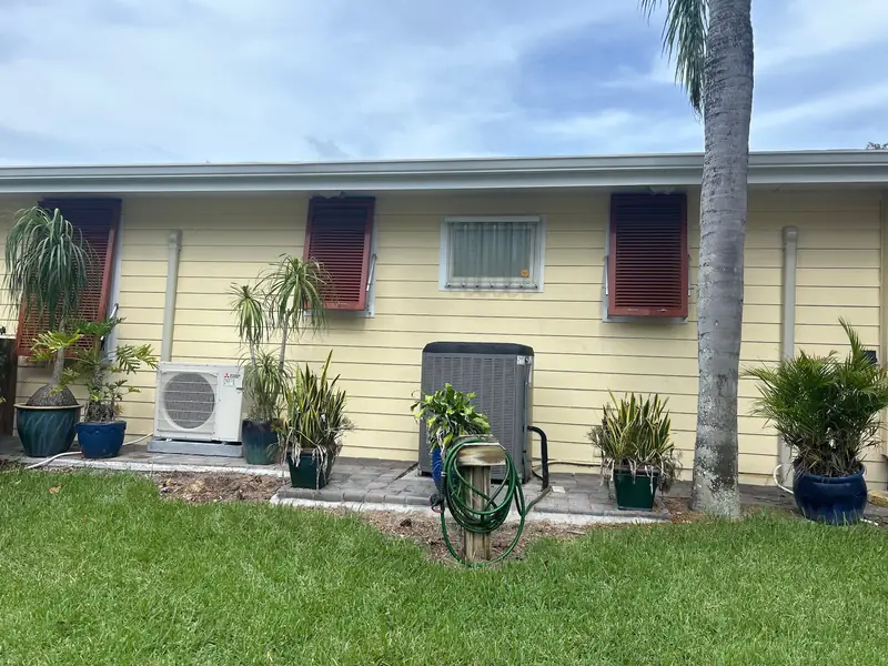 Ductless mini-split condensers mounted outside a home