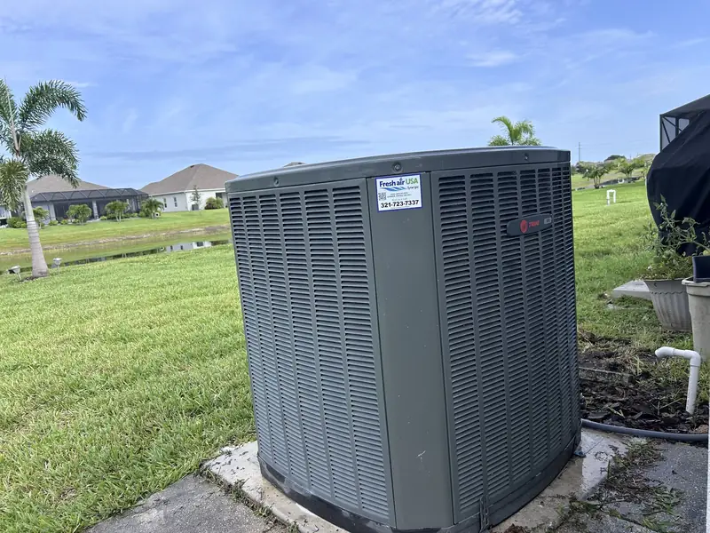Newly installed residential condenser on a level pad