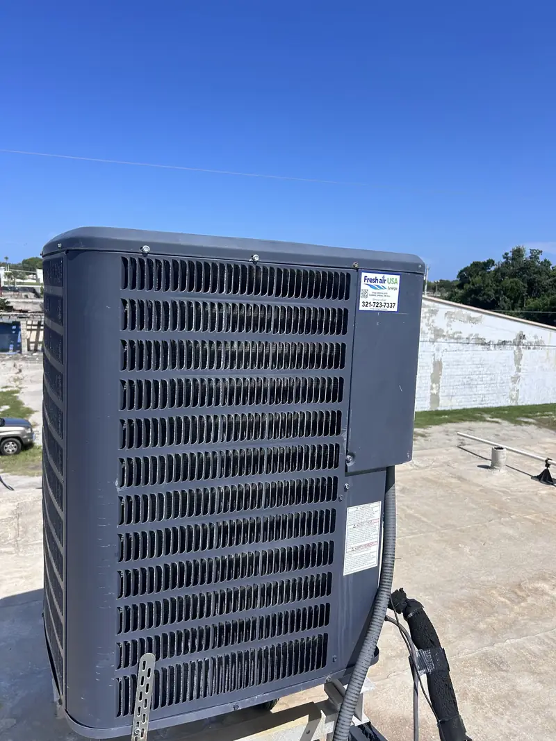 Residential air conditioning condenser on a concrete pad