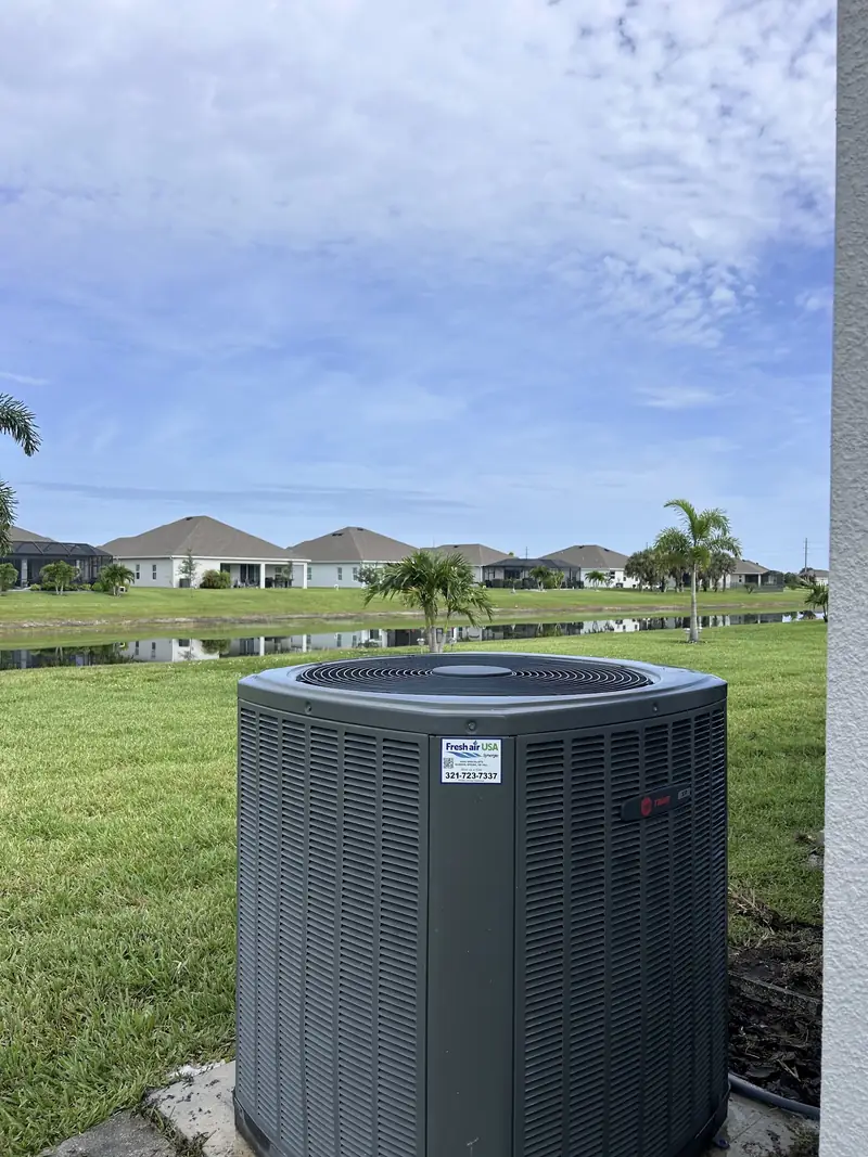 Residential condenser on an open lawn