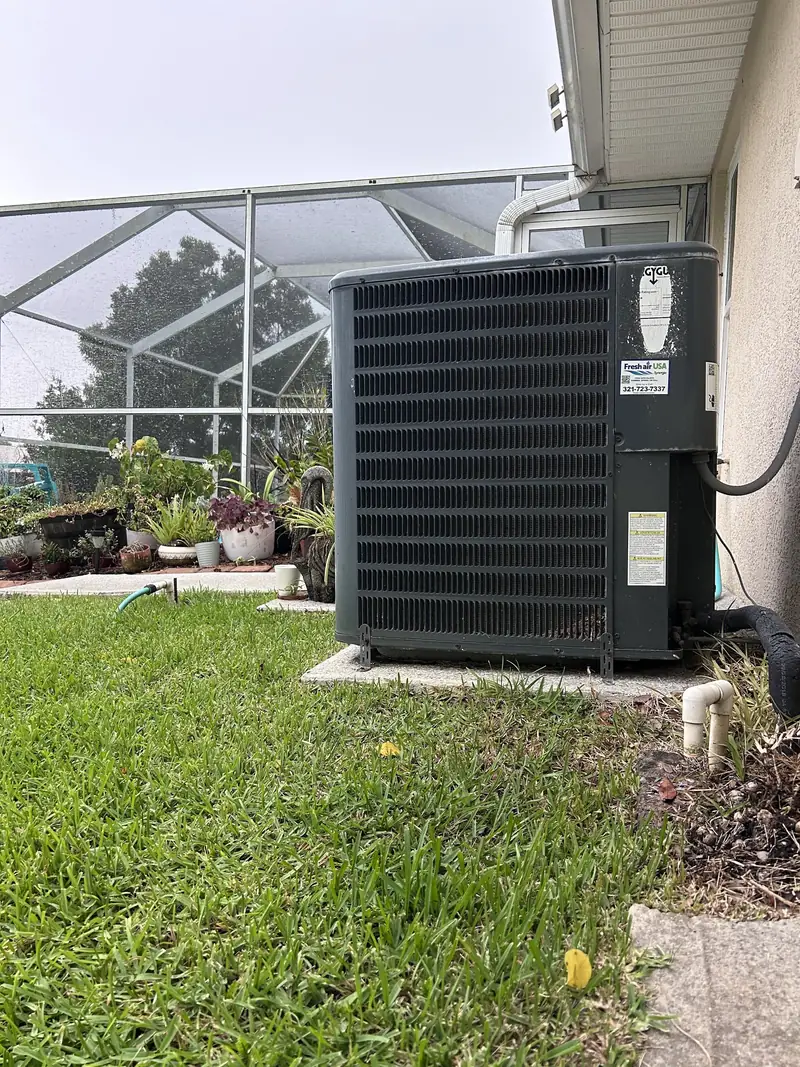 Condenser installed beside a screened lanai