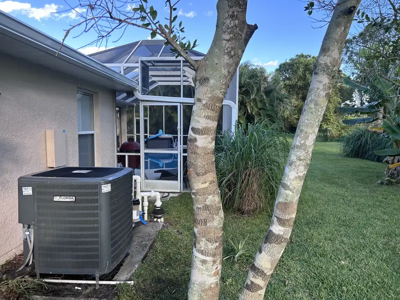 Residential condenser among palms