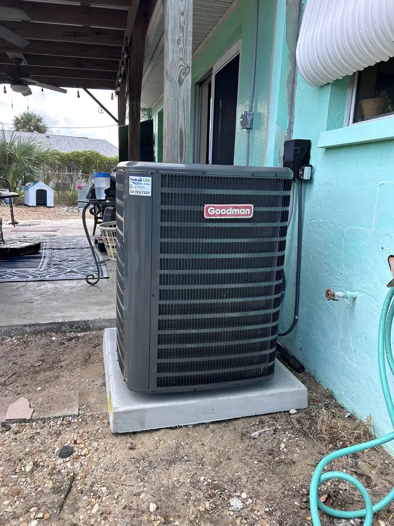 Goodman condenser installed beside a home exterior