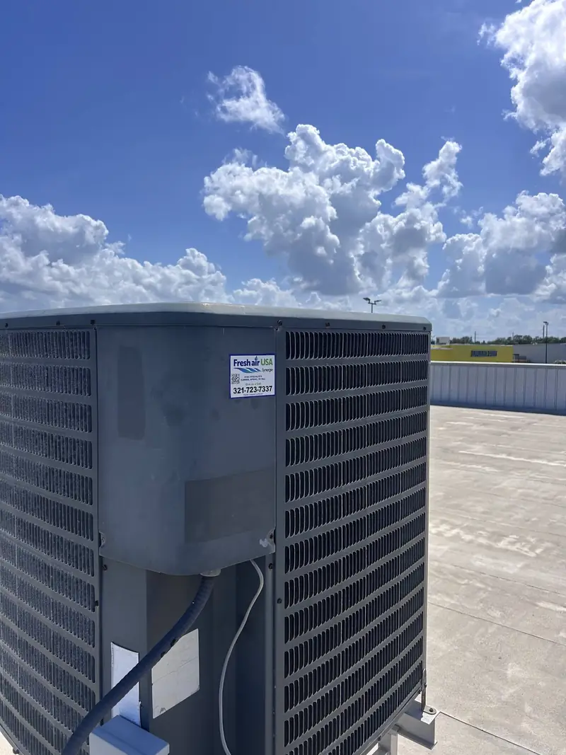 Residential condenser under a clear sky