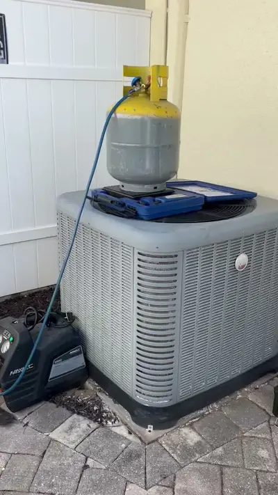 Refrigerant recovery in progress at a condensing unit